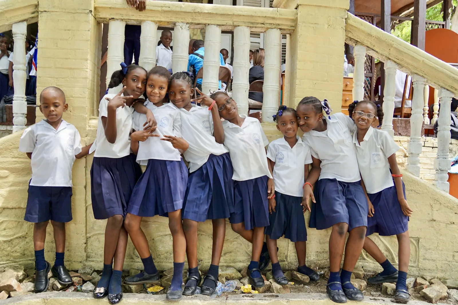 Haitian schoolchildren in uniform in front of their school