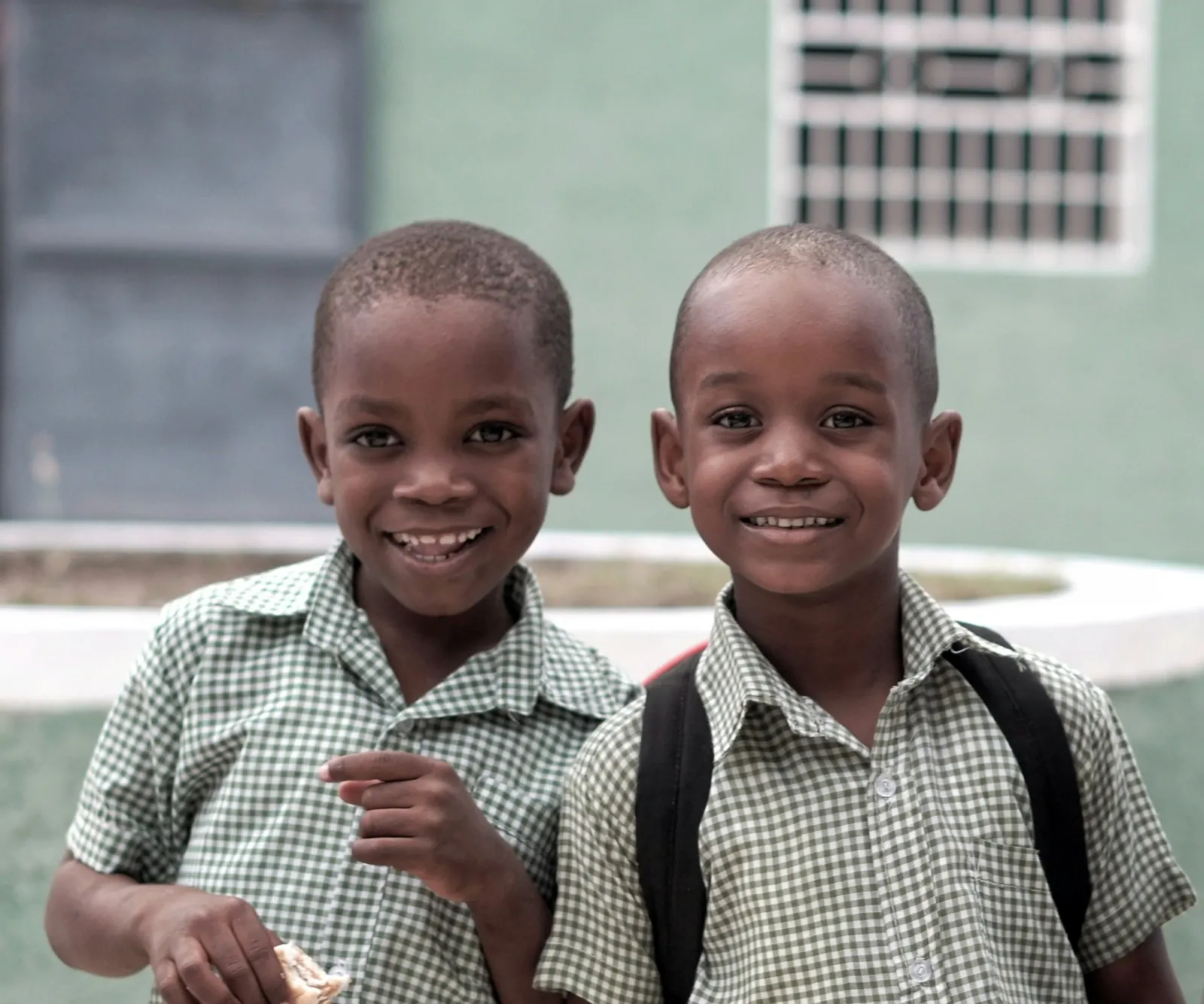 Two smiling boys in school uniform