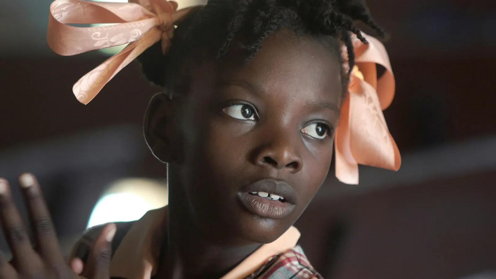 Attentive girl with ribbons in her hair