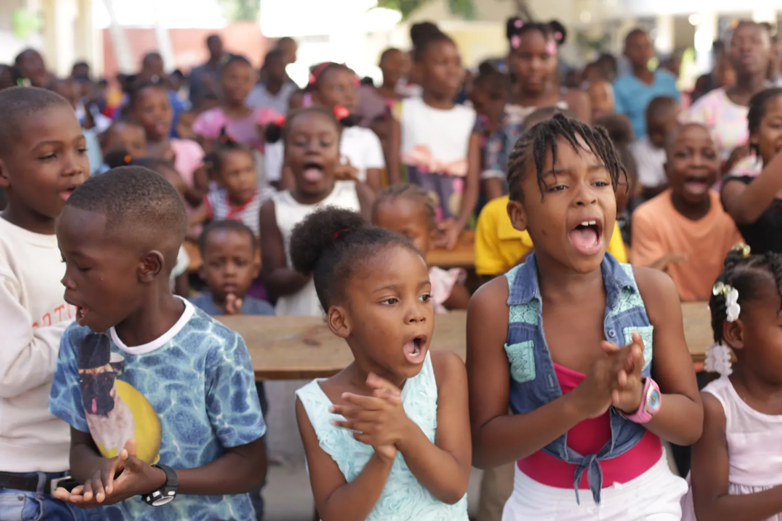 Enthusiastic children singing during a club