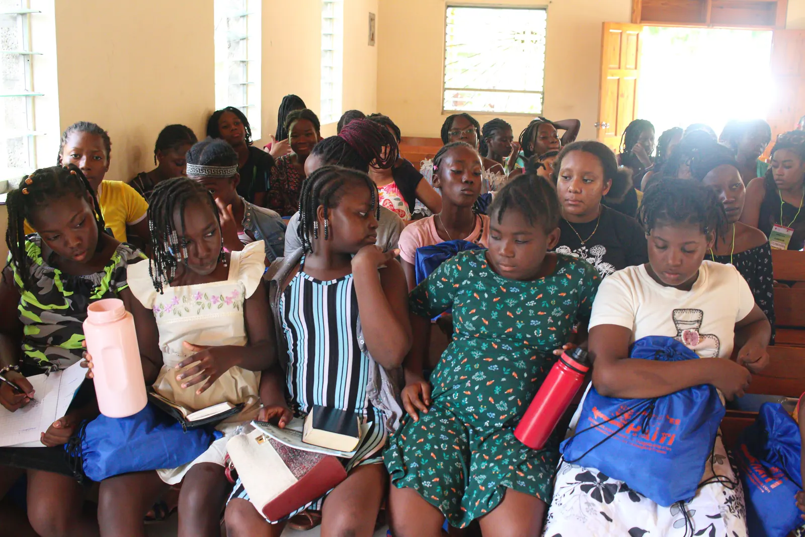 Teenagers of the JCA camp gathered indoors