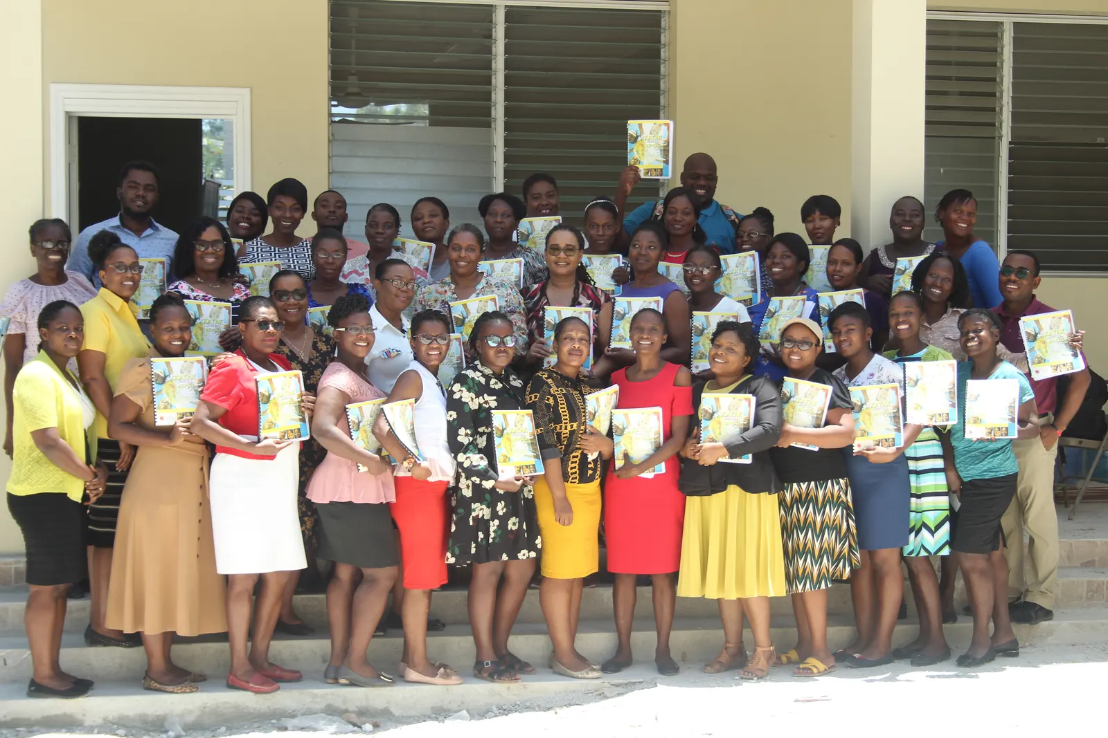 Graduating teachers posing with their certificates